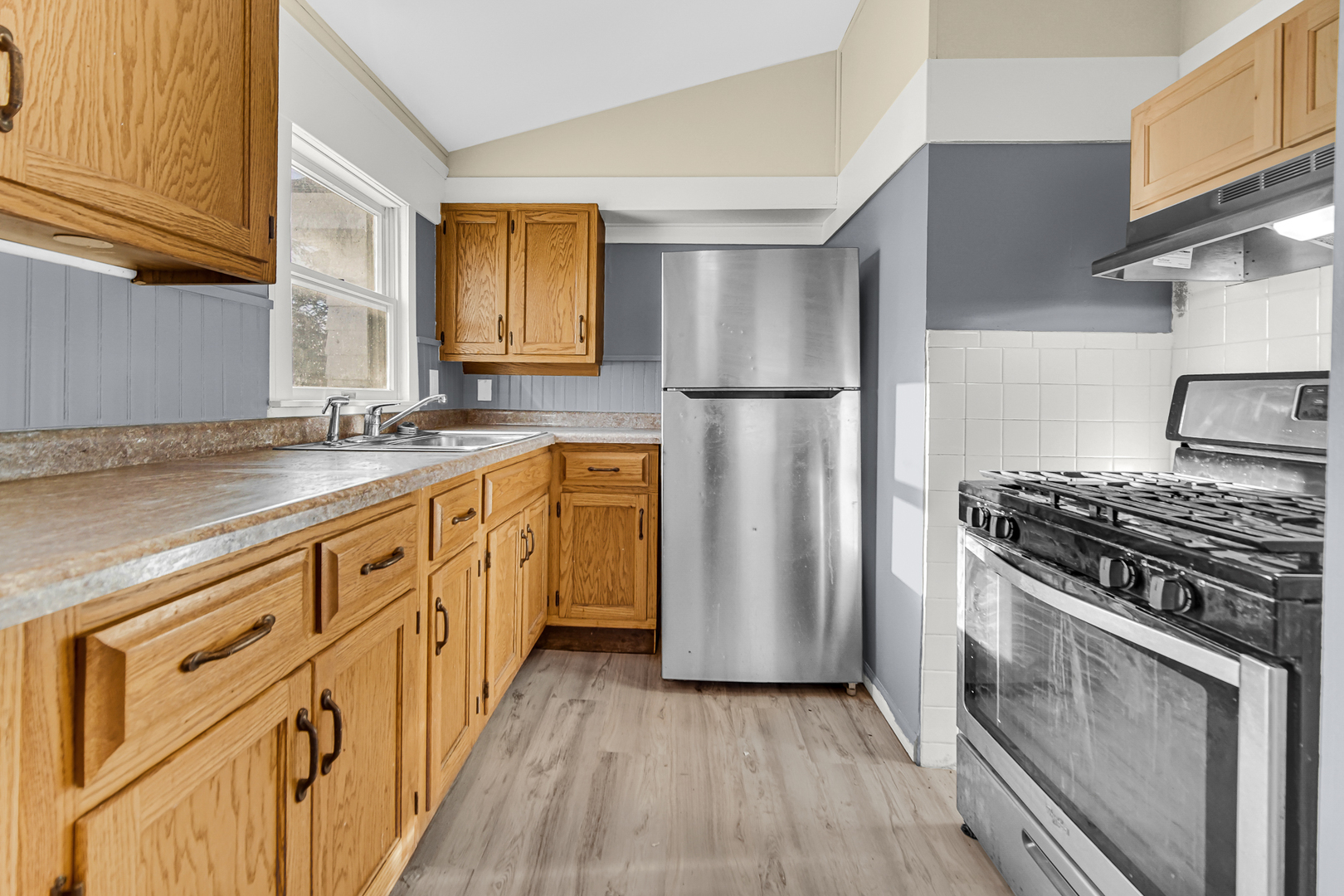 15409 Joliet Road Plainfield, IL 60544 - Photo 18 of 32 a kitchen with stainless steel appliances granite countertop a stove a refrigerator and a sink