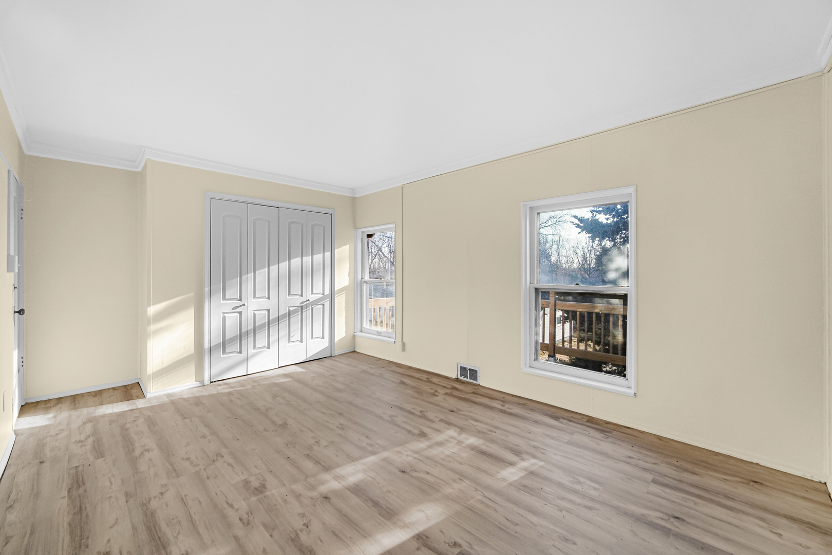 15409 Joliet Road Plainfield, IL 60544 - Photo 24 of 32 a view of an empty room with a window and wooden floor