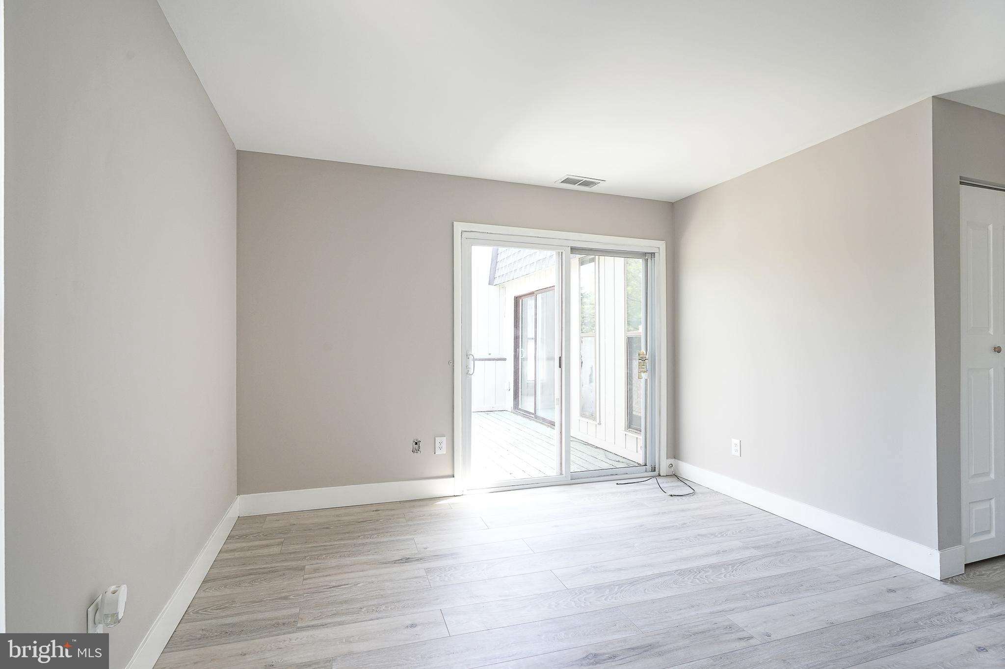 25 South Church Road, Unit 138 Maple Shade, NJ 08052 - Photo 20 of 23 an empty room with wooden floor and windows
