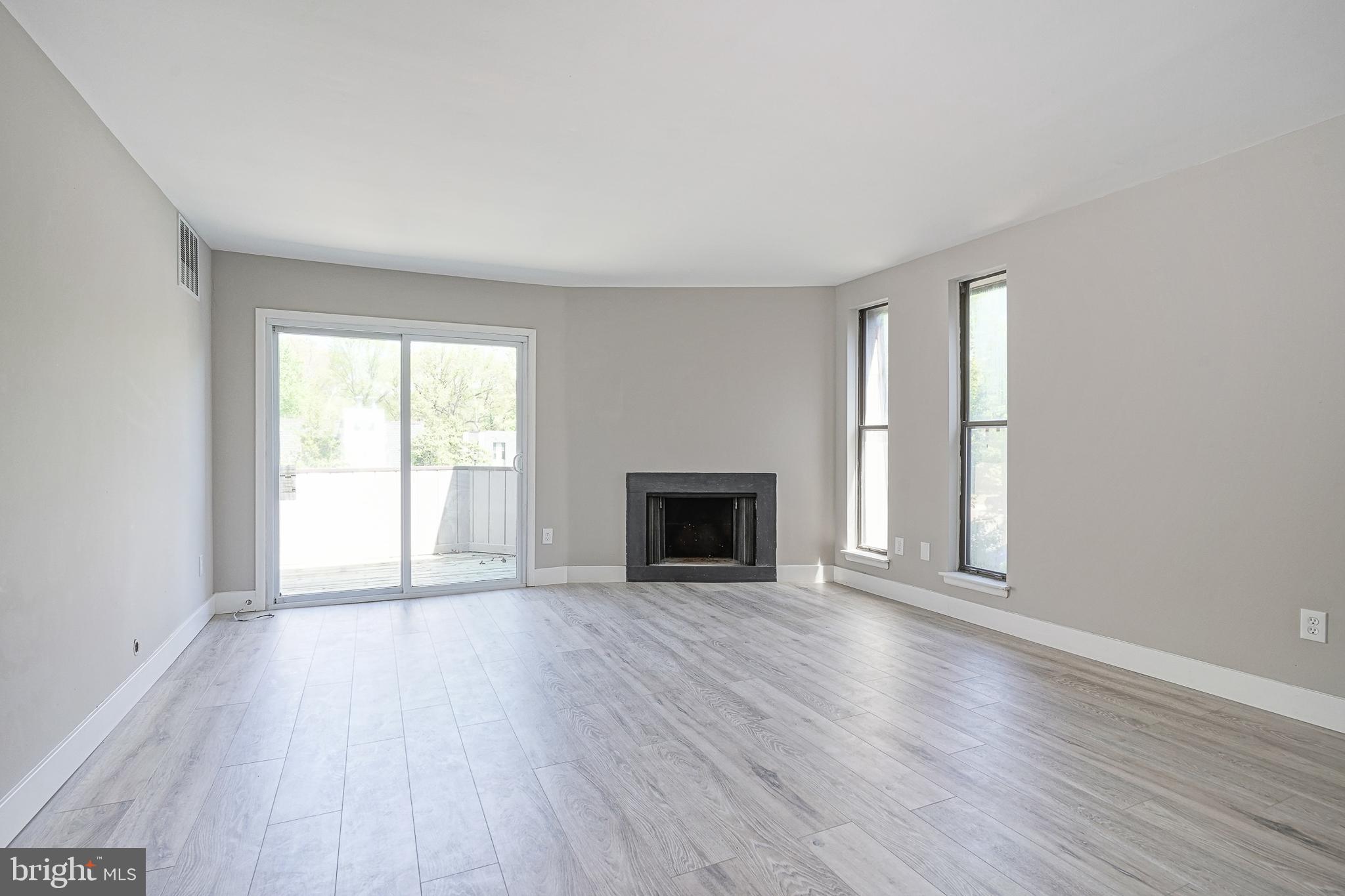 25 South Church Road, Unit 138 Maple Shade, NJ 08052 - Photo 3 of 23 an empty room with wooden floor fireplace and windows