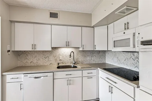 a bedroom with a large bed and wooden floor