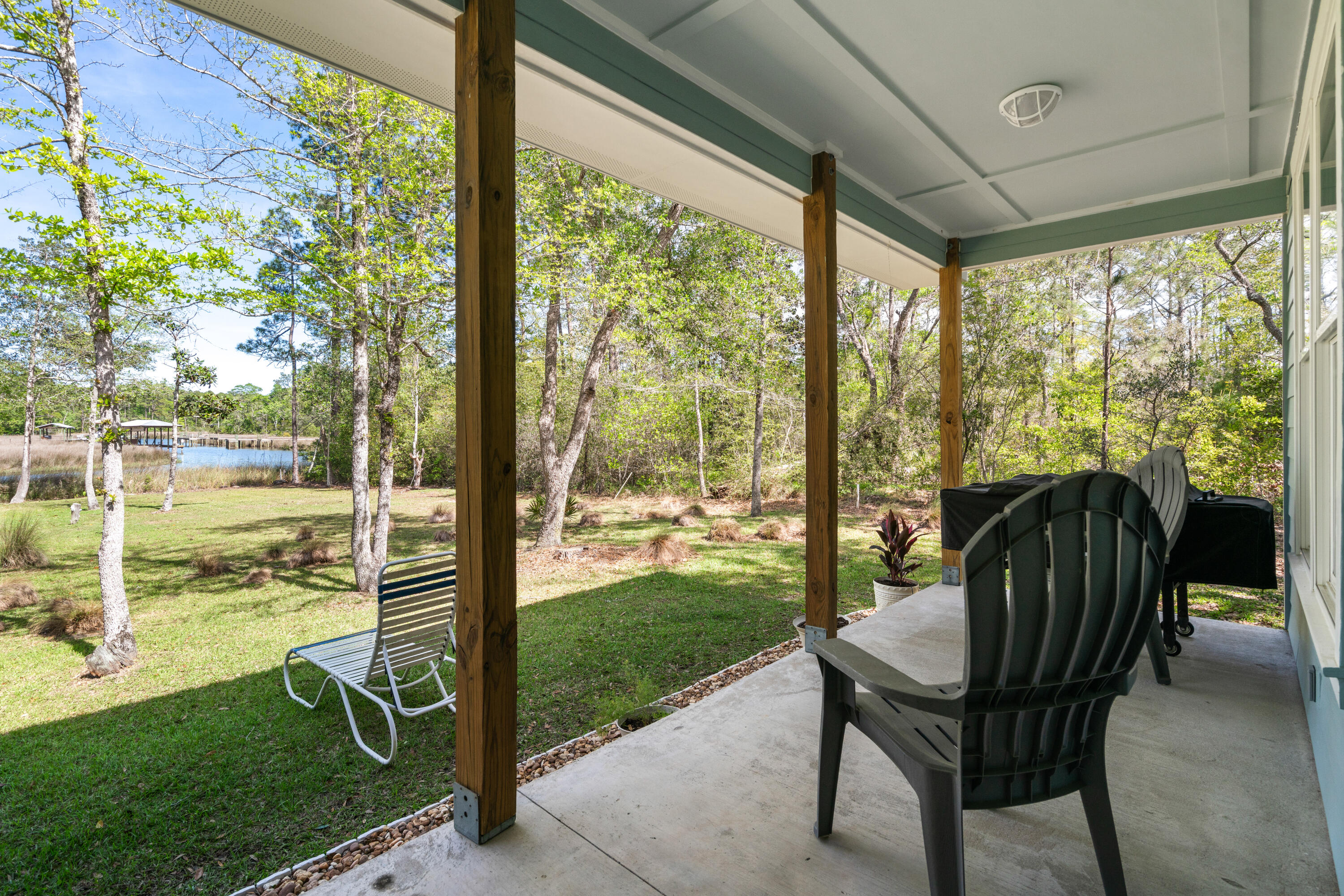 528 Bay Grove Road Freeport, FL 32439 - Photo 33 of 68 a view of a porch with a table chairs and a yard