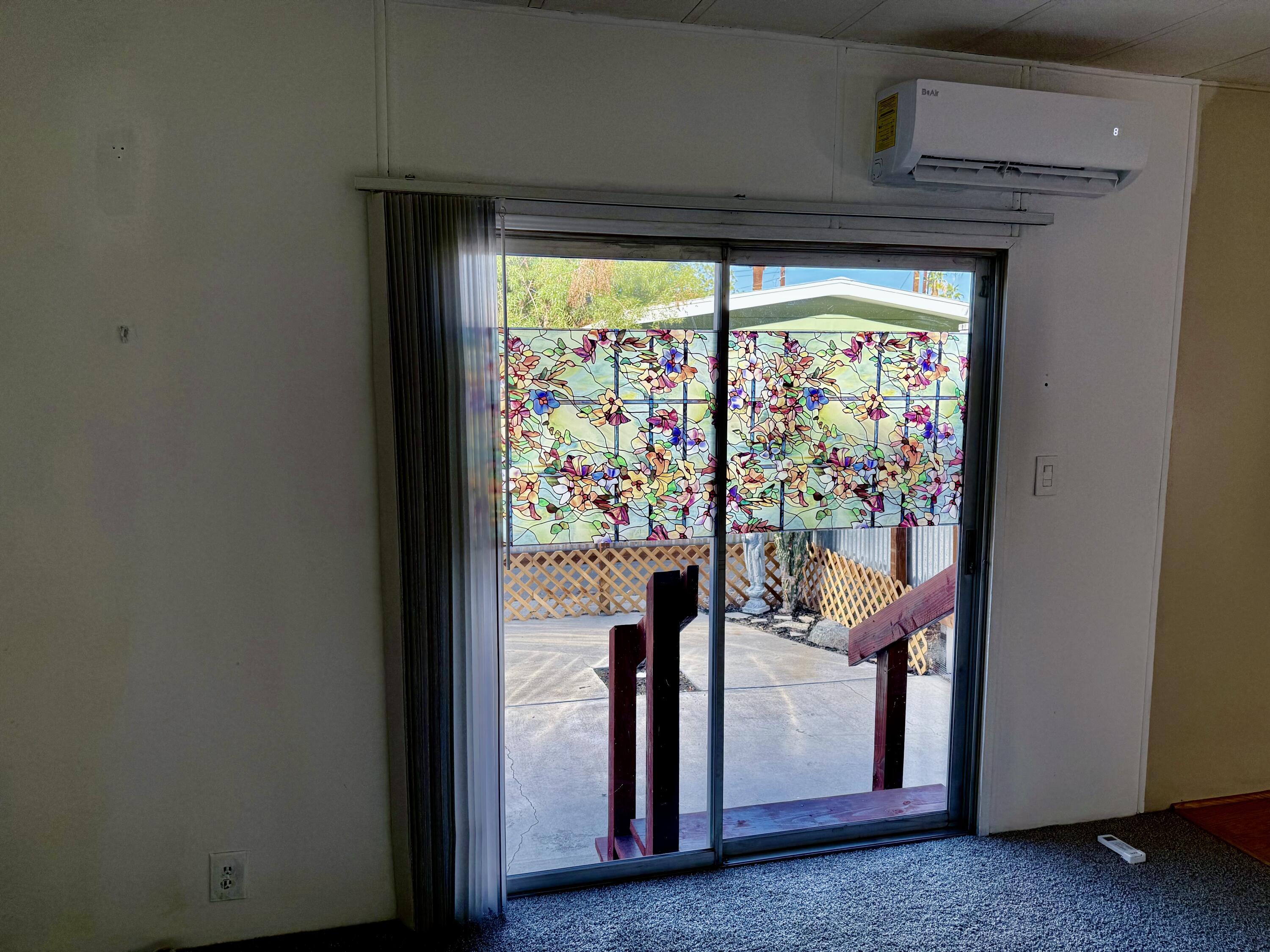 22 Jupiter Street Palm Springs, CA 92264 - Photo 16 of 35 a view of a hallway with wooden floor and a refrigerator