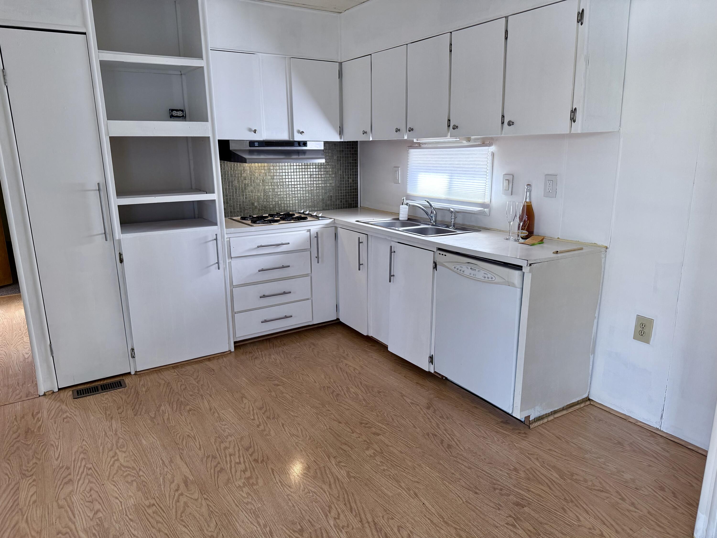 22 Jupiter Street Palm Springs, CA 92264 - Photo 17 of 35 a kitchen with white cabinets and white appliances