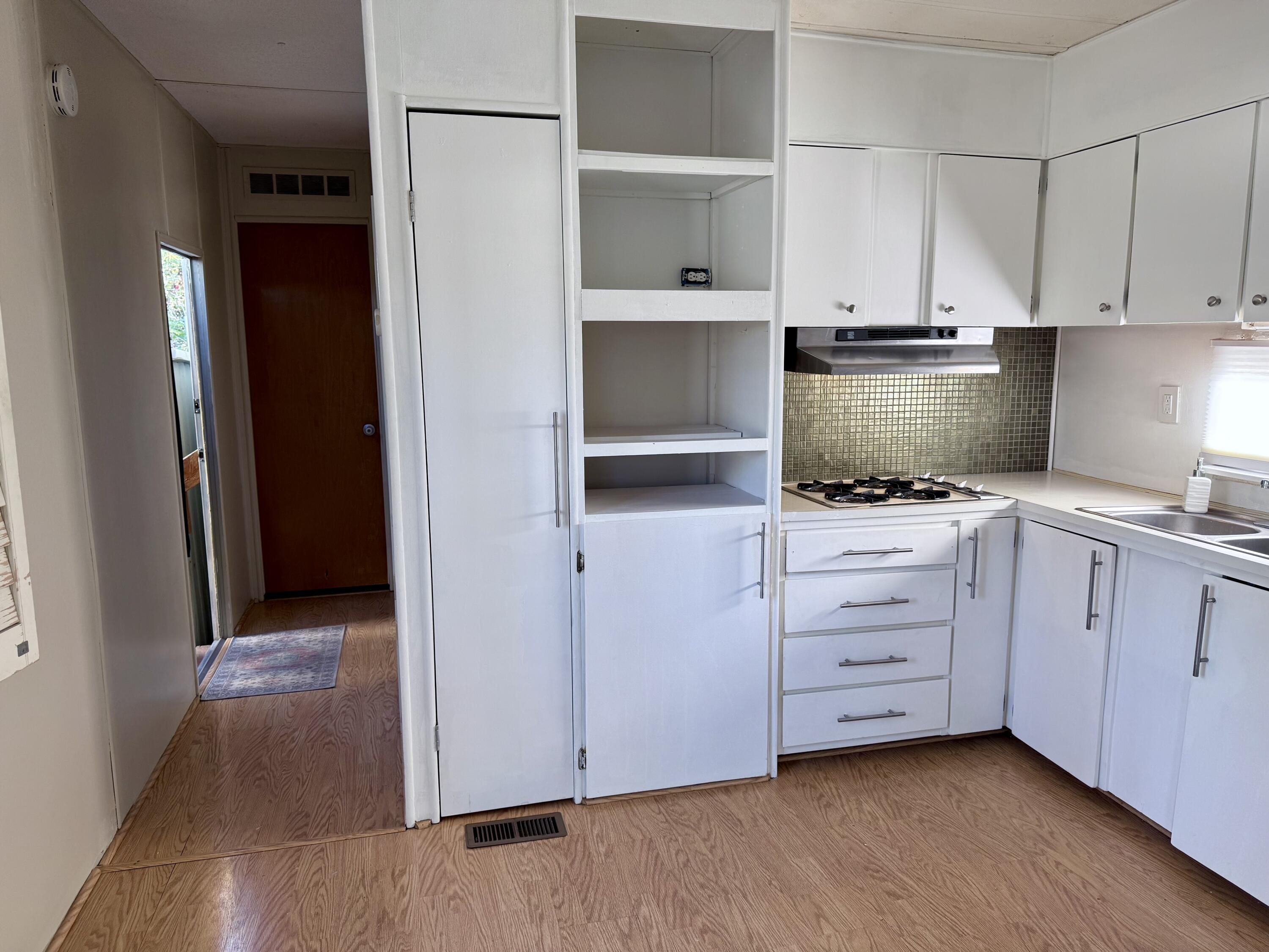 22 Jupiter Street Palm Springs, CA 92264 - Photo 18 of 35 a kitchen with white cabinets and appliances