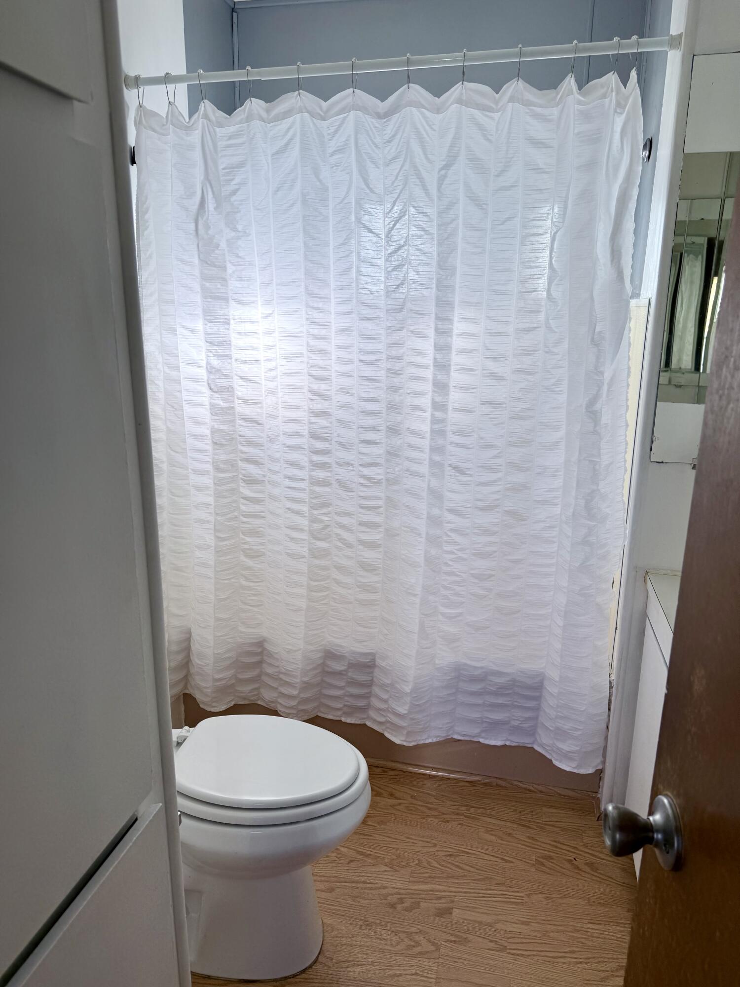 22 Jupiter Street Palm Springs, CA 92264 - Photo 25 of 35 a bathroom with a toilet and a shower curtain