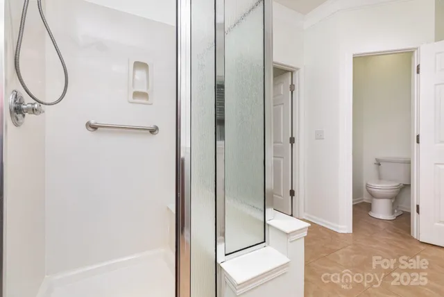 a view of bathroom with a toilet and a shower
