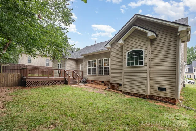 a view of a house with a yard and sitting area