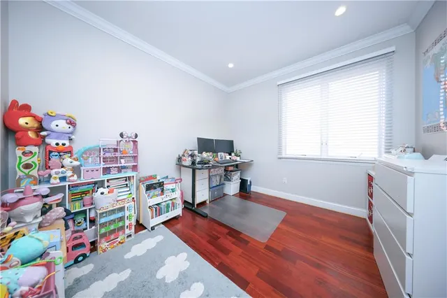 a room with furniture a baby crib and a window