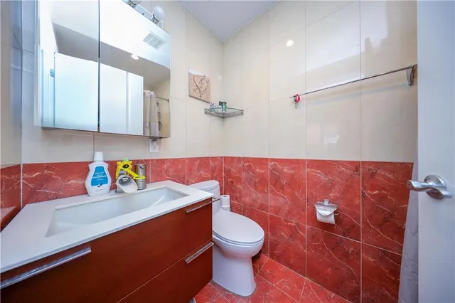 a bathroom with a sink a toilet and a shower