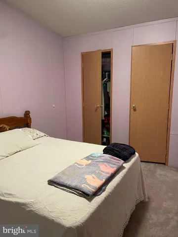 a bedroom with a bed and cabinets