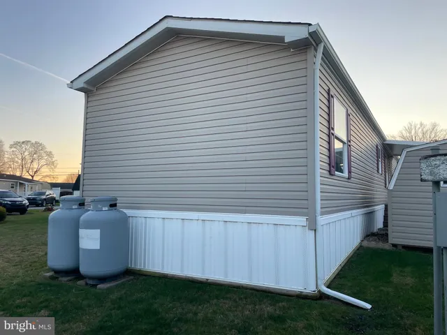 a view of backyard with barbeque grill and a wooden fence