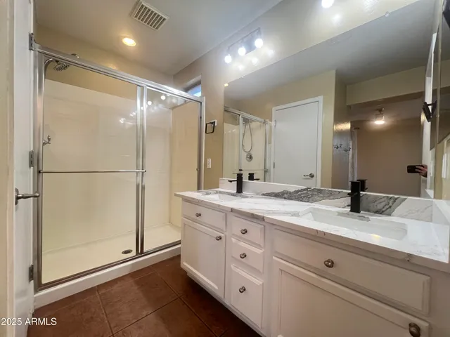 a bathroom with a granite countertop sink mirror and double
