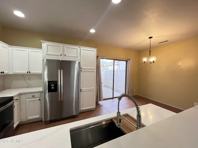a kitchen with a refrigerator and a sink