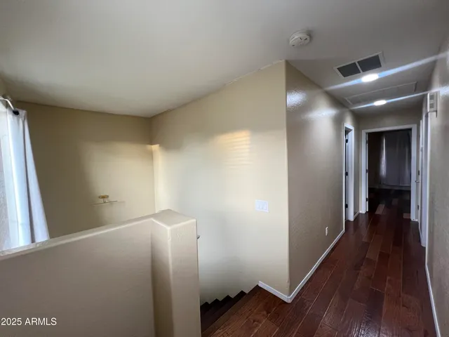 a view of hallway with wooden floor