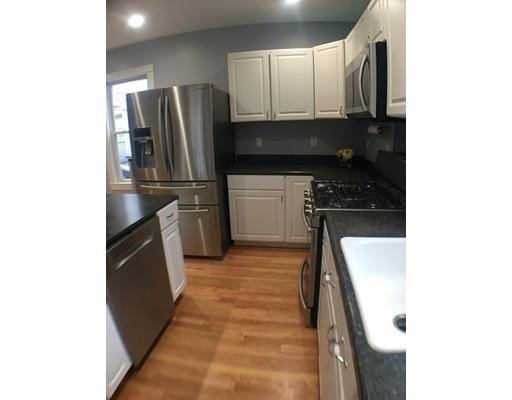 12 Johnston Terrace Saugus, MA 01906 - Photo 2 of 24 a kitchen with a refrigerator and a stove