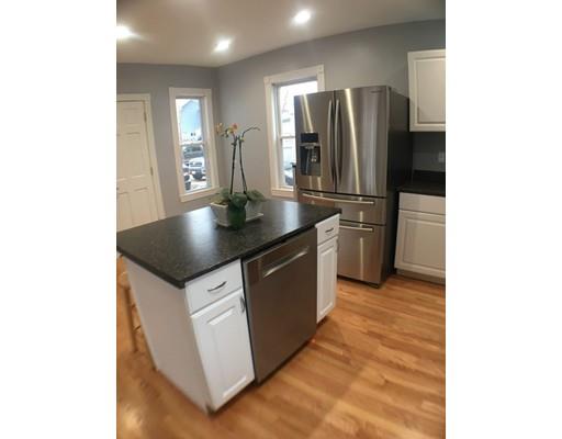 12 Johnston Terrace Saugus, MA 01906 - Photo 4 of 24 a kitchen with stainless steel appliances granite countertop a refrigerator a sink and a stove