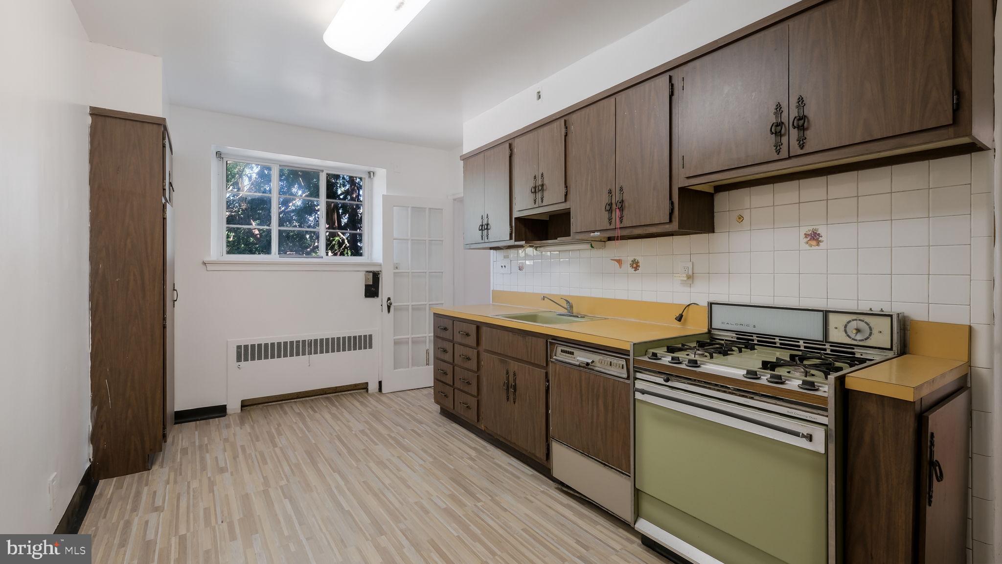 1500 Hellerman Street Philadelphia, PA 19149 - Photo 12 of 31 a kitchen with stainless steel appliances a stove a sink a refrigerator and cabinets