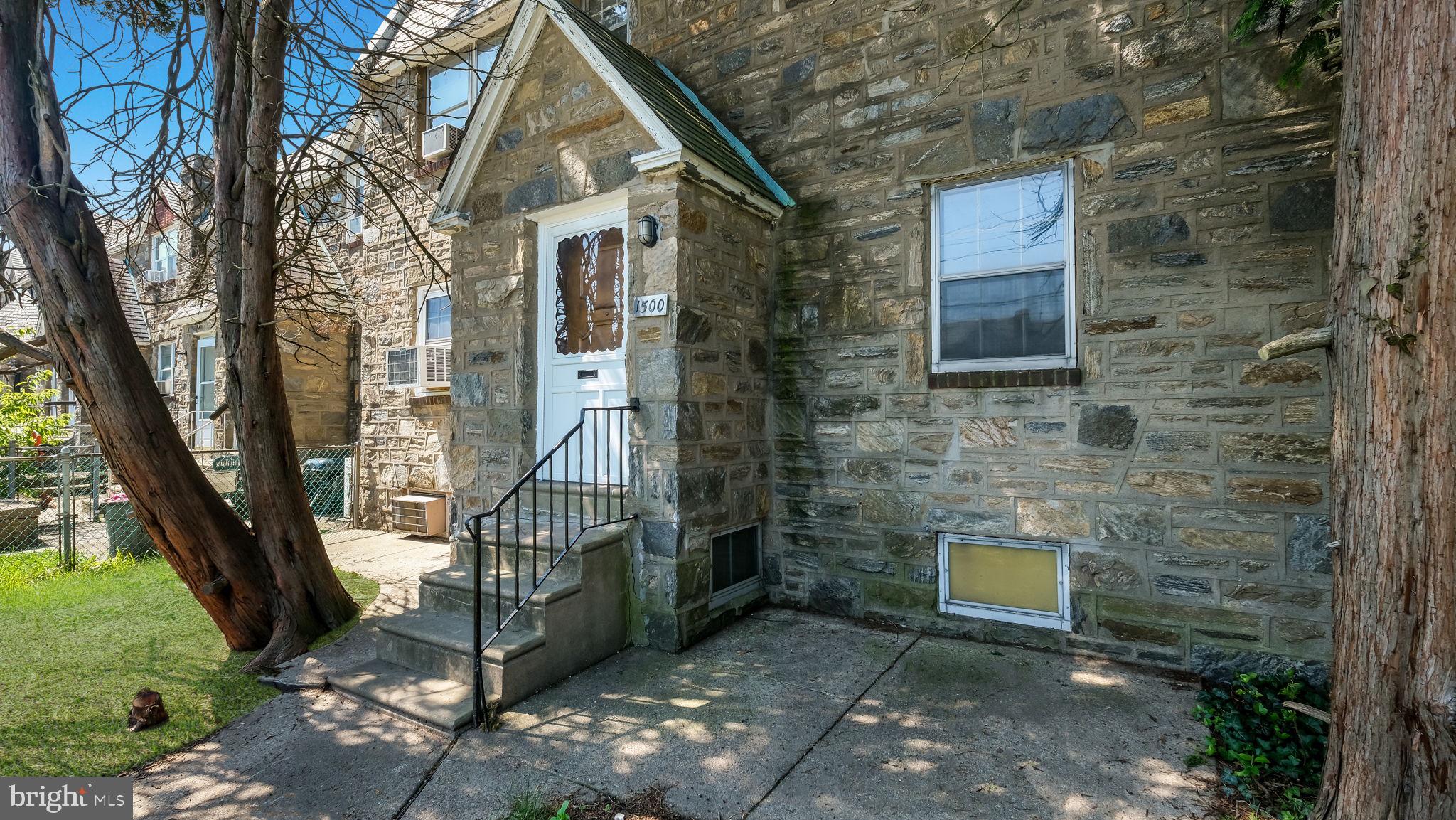 1500 Hellerman Street Philadelphia, PA 19149 - Photo 6 of 31 a view of a brick house with a small yard and large tree