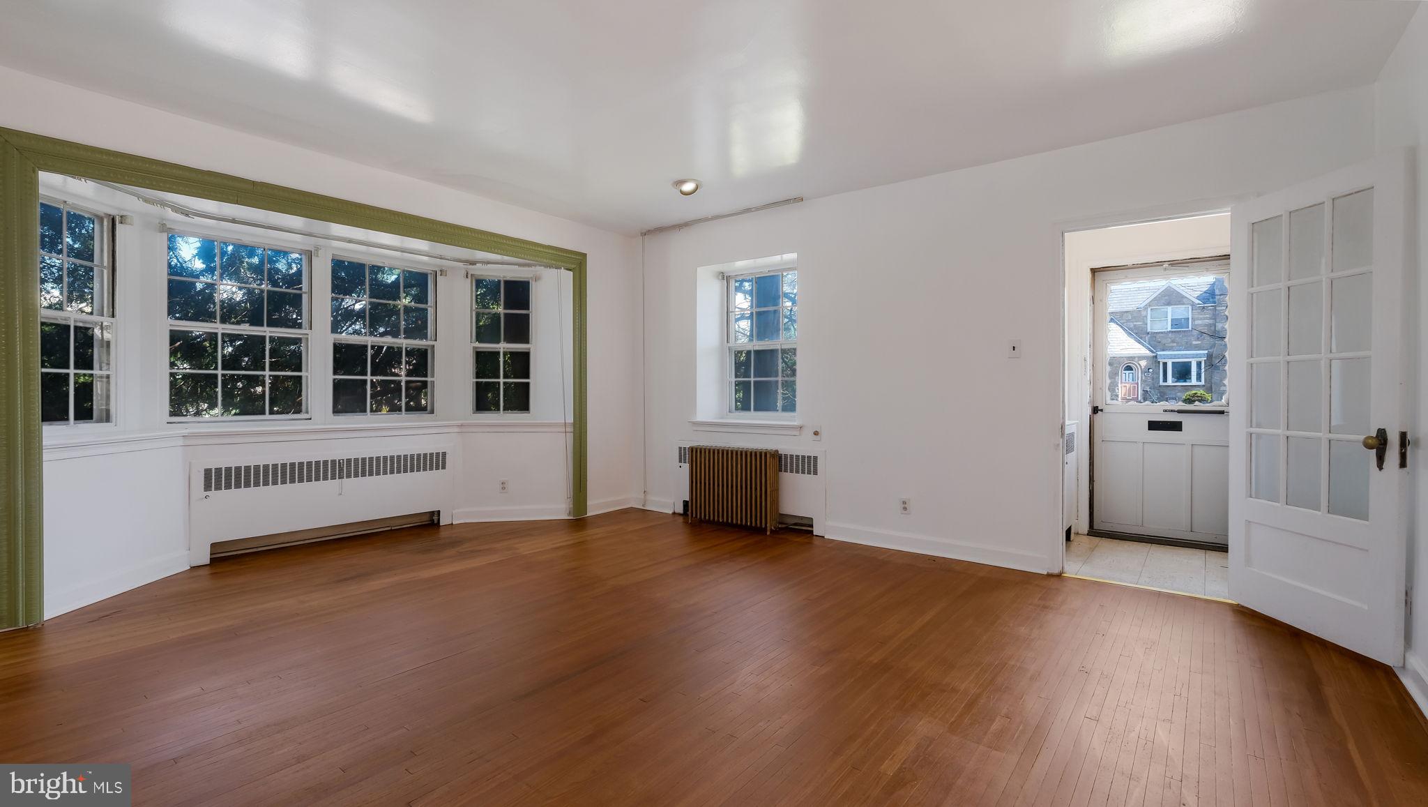 1500 Hellerman Street Philadelphia, PA 19149 - Photo 7 of 31 an empty room with wooden floor and windows