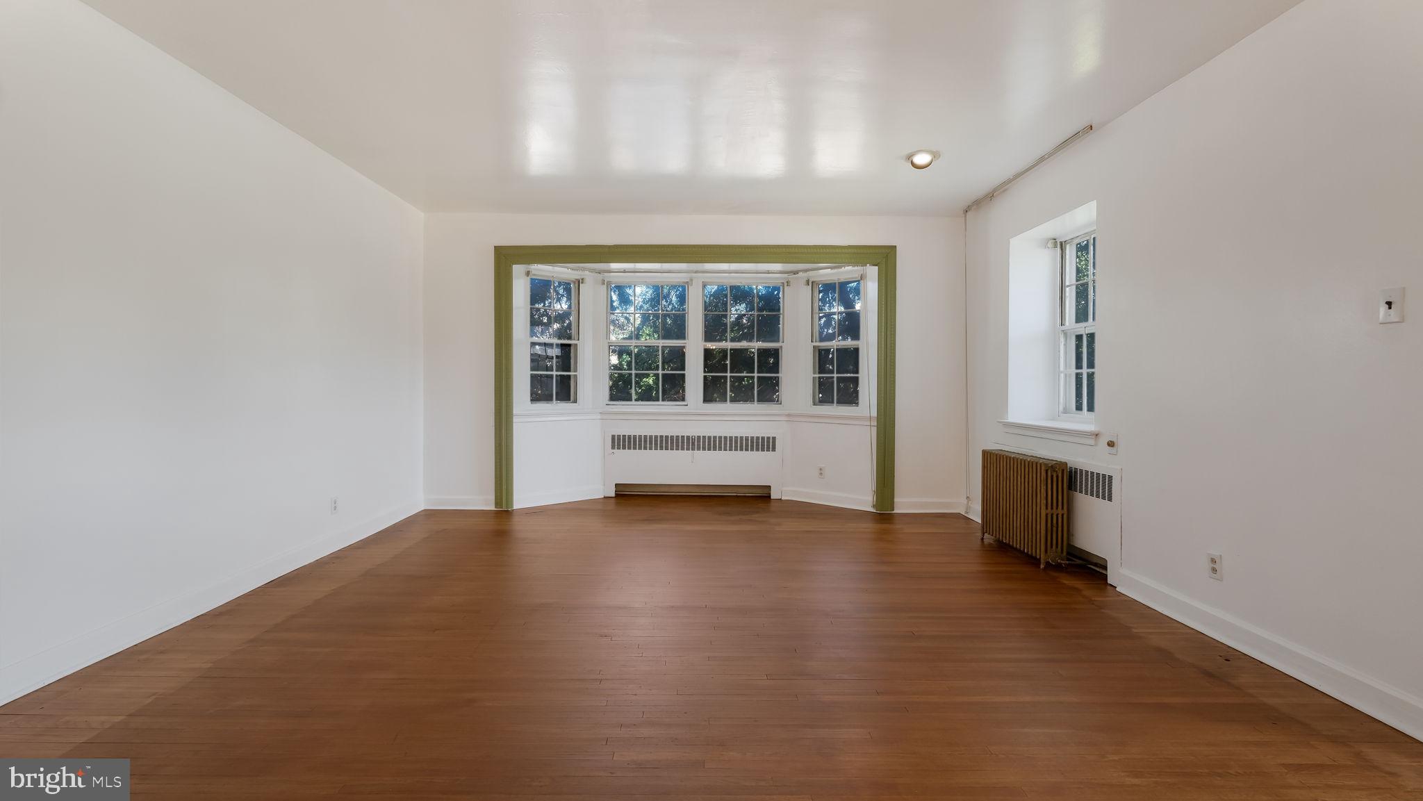 1500 Hellerman Street Philadelphia, PA 19149 - Photo 8 of 31 an empty room with wooden floor and windows