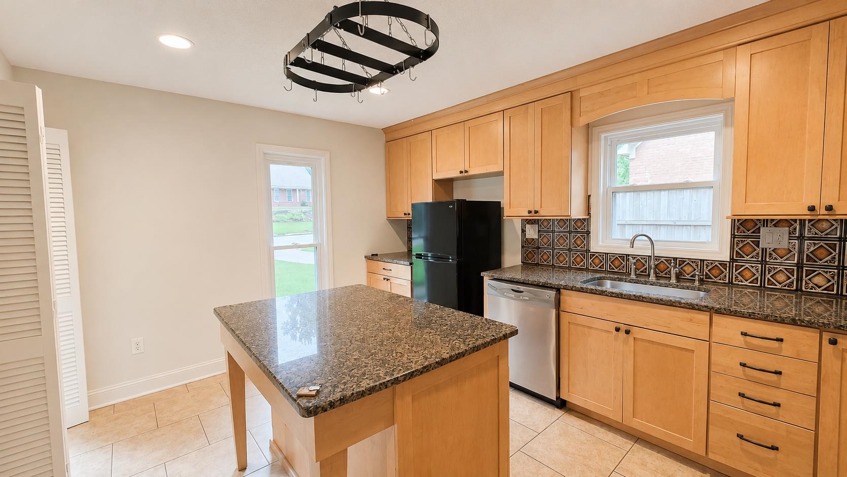 89 Ericson Road Memphis, TN 38018 - Photo 10 of 36 a kitchen with granite countertop a sink a counter space and stainless steel appliances