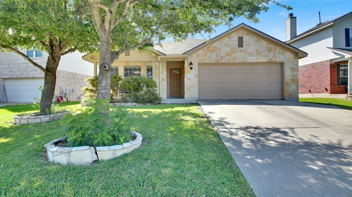 18409 Hees Lane Pflugerville, TX 78660 - Photo 1 of 1 a front view of a house with a yard and garage