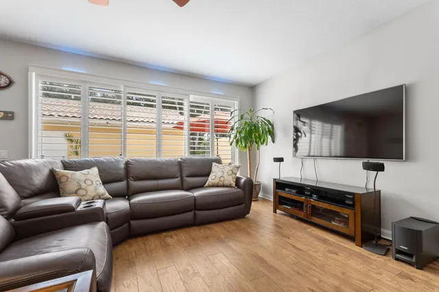 a view of a hallway with wooden floor and entryway