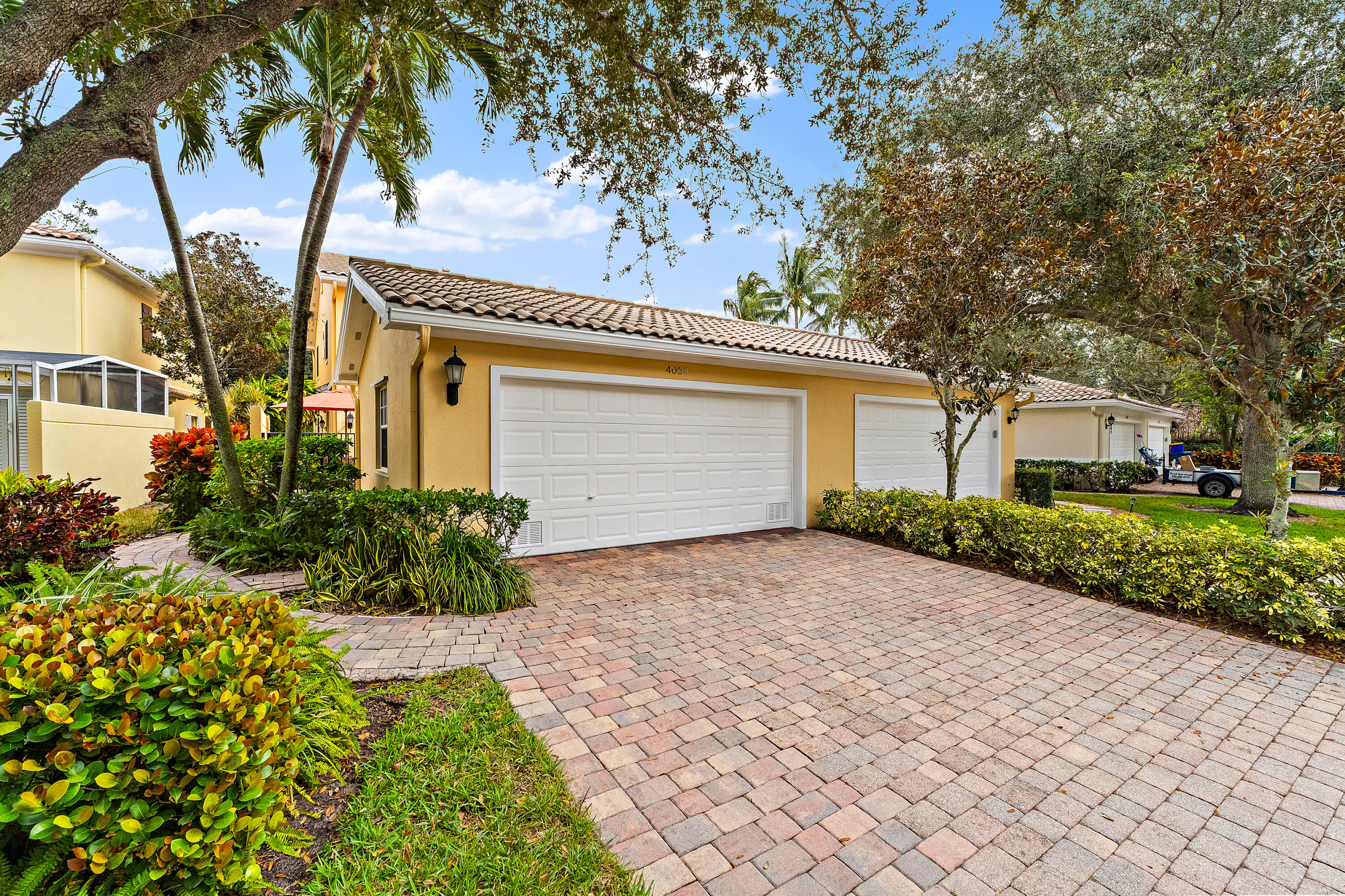 4050 Parkside Drive Jupiter, FL 33458 - Photo 51 of 59 a front view of a house with a garden
