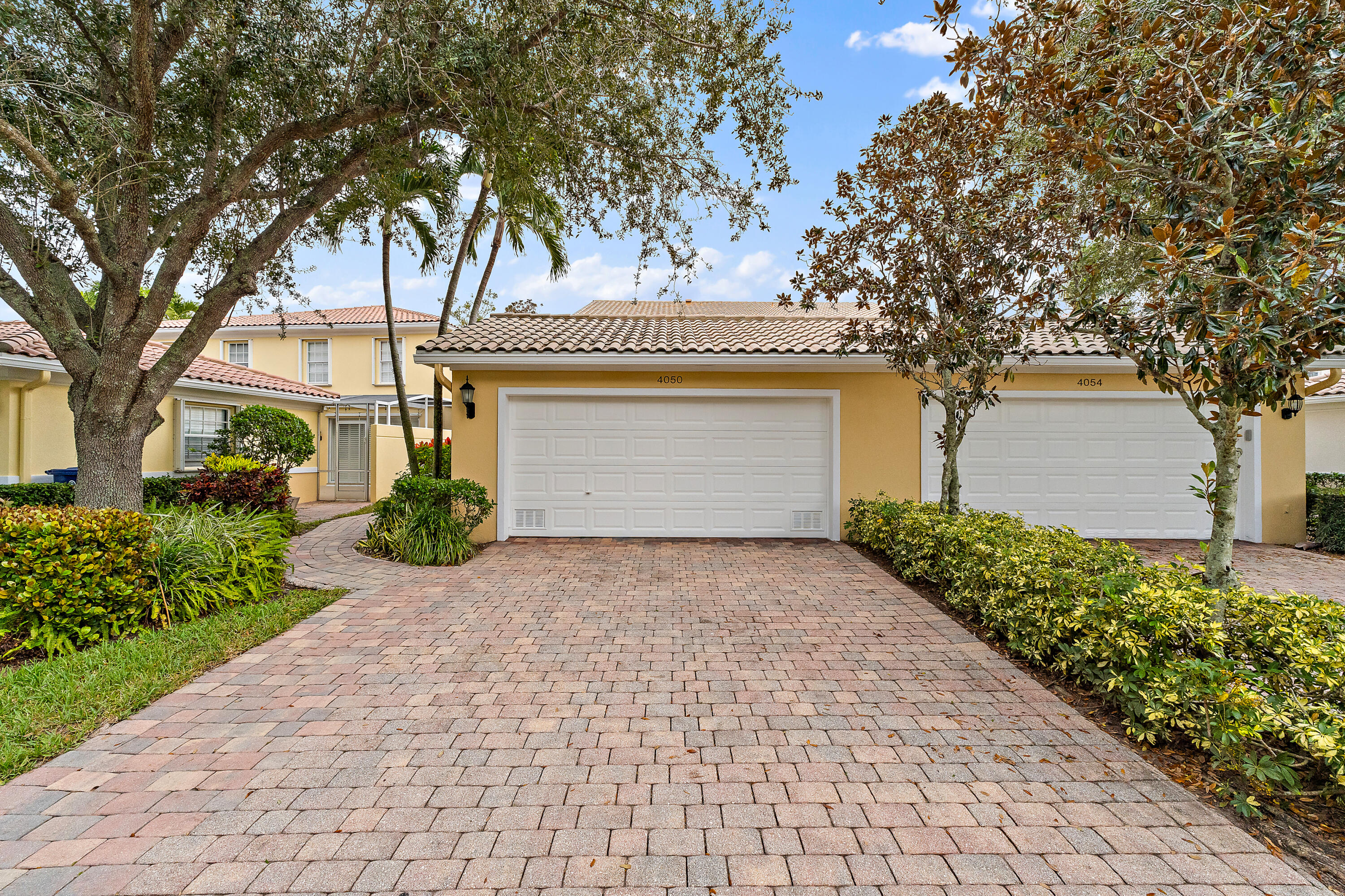 4050 Parkside Drive Jupiter, FL 33458 - Photo 52 of 59 a front view of a house with garden