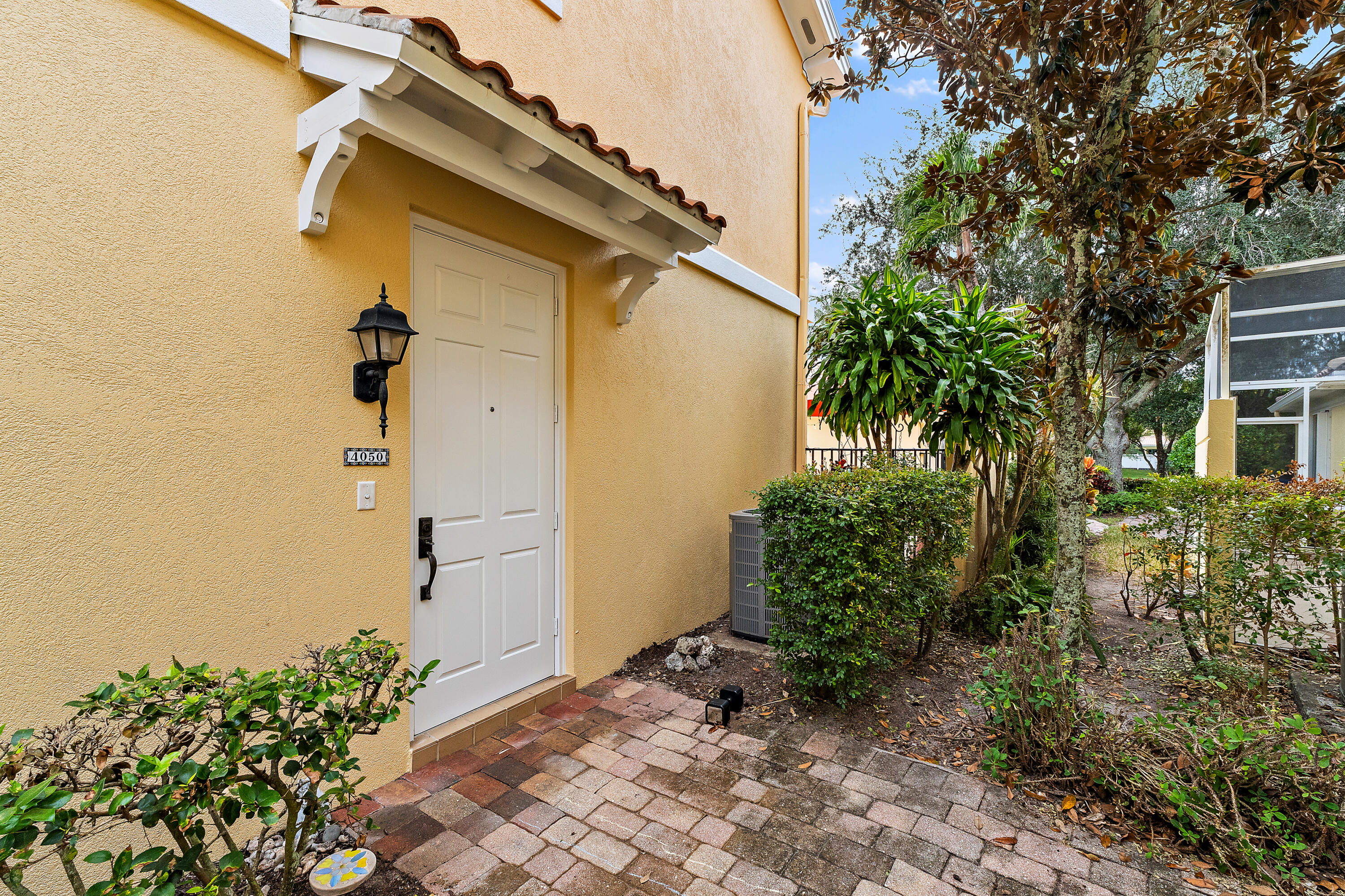 4050 Parkside Drive Jupiter, FL 33458 - Photo 8 of 59 a view of a pathway of a house with potted plants