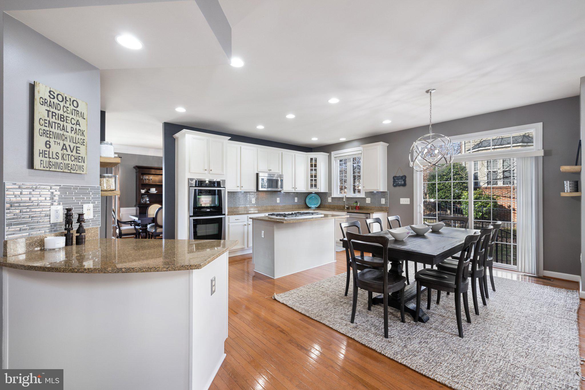 42624 Emperor Ashburn, VA 20148 - Photo 12 of 56 a kitchen with stainless steel appliances granite countertop a dining table chairs and granite counter tops
