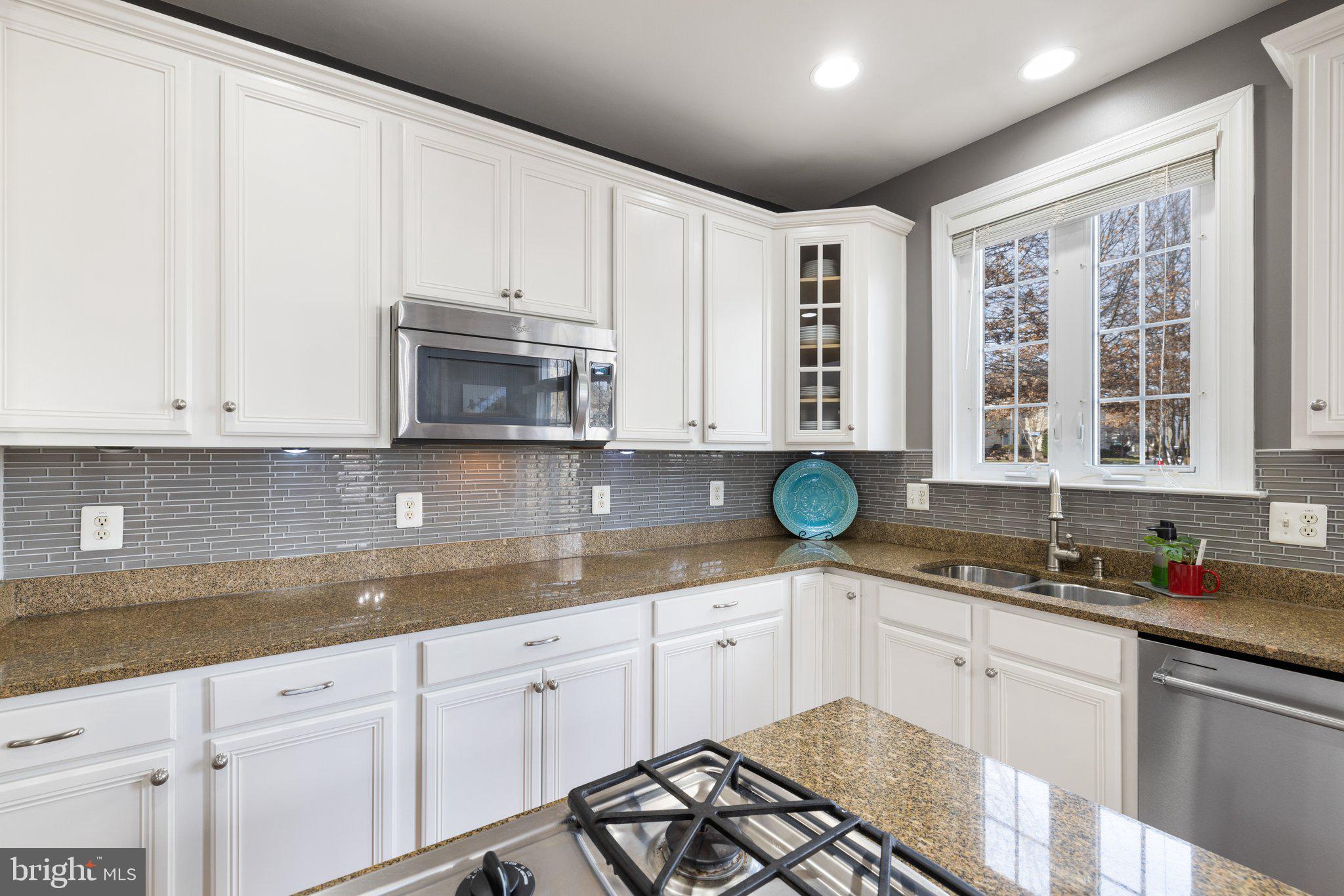 42624 Emperor Ashburn, VA 20148 - Photo 13 of 56 a kitchen with granite countertop white cabinets white stainless steel appliances and sink