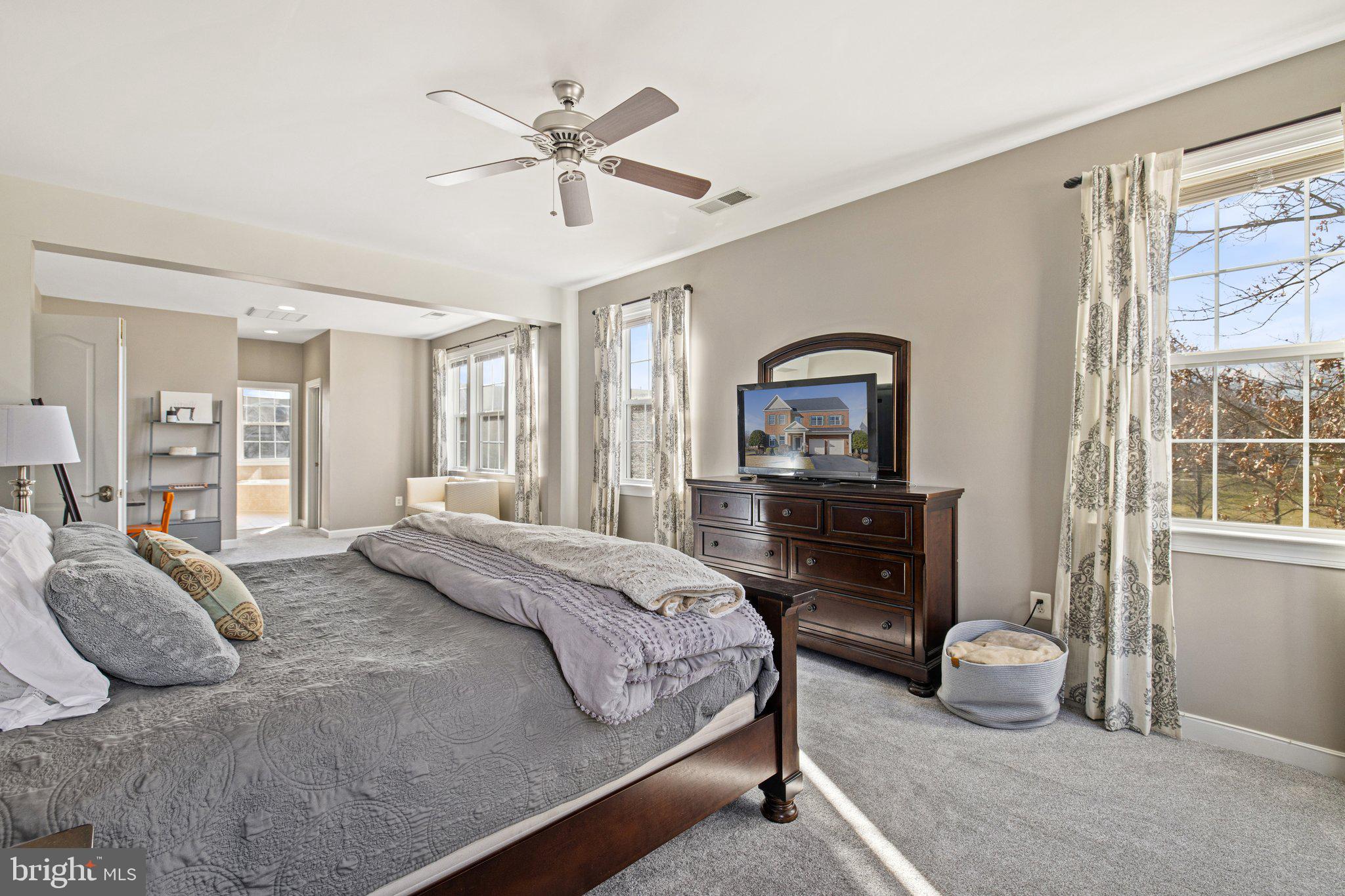 42624 Emperor Ashburn, VA 20148 - Photo 24 of 56 a bedroom with a large bed and a chandelier