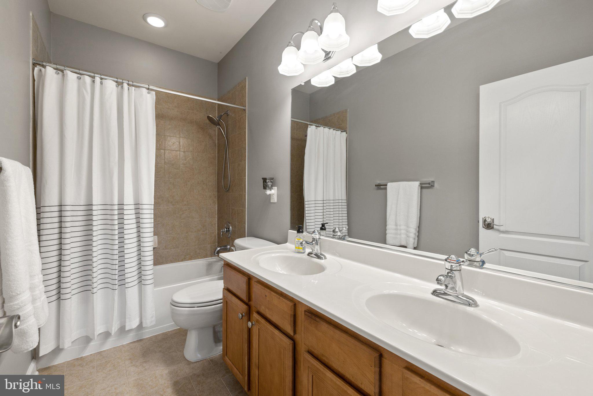 42624 Emperor Ashburn, VA 20148 - Photo 31 of 56 a bathroom with a double vanity sink and a mirror