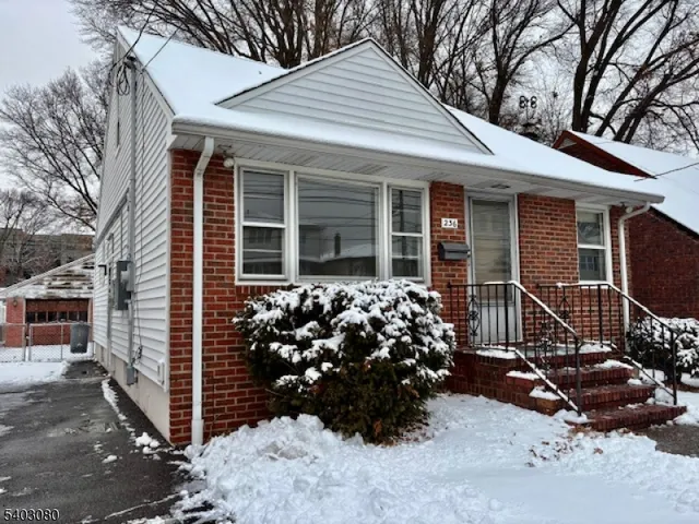 a view of a house with a yard and covered space