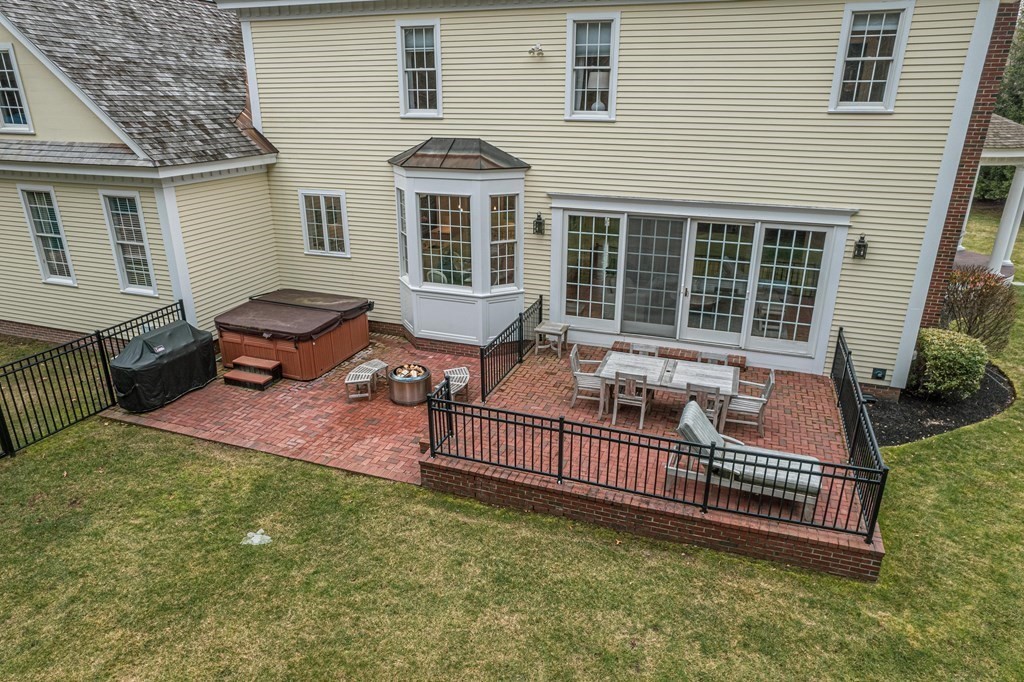 5 Rose Lane Boxford, MA 01921 - Photo 7 of 8 a backyard of a house with barbeque oven and wooden fence
