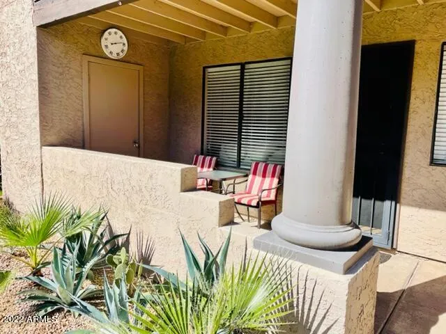 a view of a house with swimming pool and sitting area