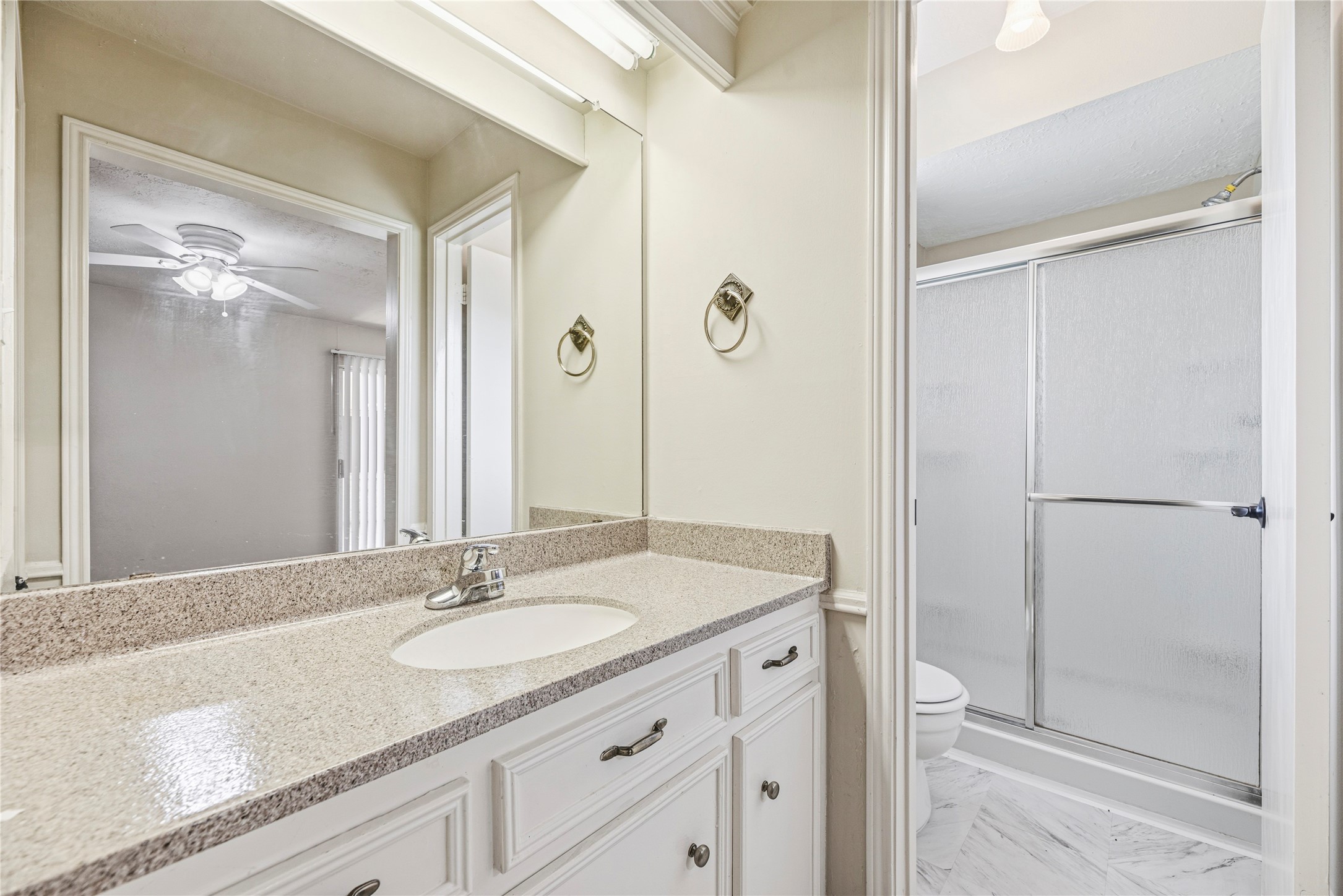6931 Sandy Knolls Drive Spring, TX 77379 - Photo 15 of 21 Your primary en-suite bathroom a clean and bright bathroom featuring a vanity with ample counter space, a mirror, and a shower with sliding glass doors.
**6931 Sandy Knolls Dr., Spring, TX 77379**