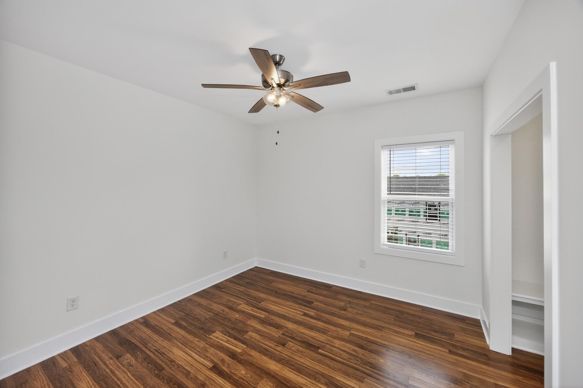 7 Decatur Street Nashville, TN 37210 - Photo 34 of 43 an empty room with wooden floor ceiling fan and windows