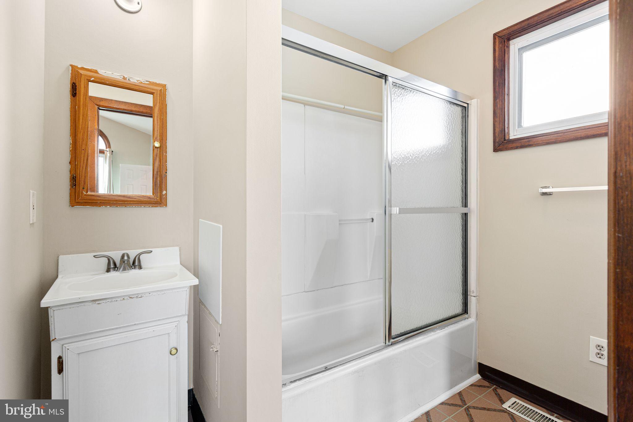 2623 Knights Road Bensalem, PA 19020 - Photo 23 of 50 a bathroom with a shower sink and mirror