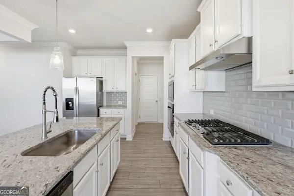 a kitchen with stainless steel appliances granite countertop a sink stove and refrigerator