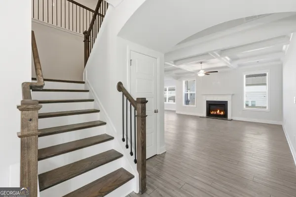 a view of a livingroom with wooden floor and fireplace