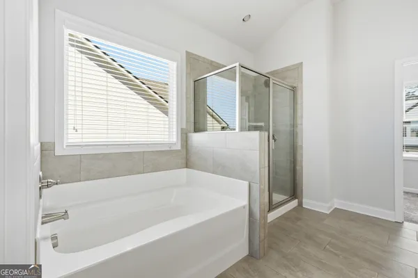 a white bath tub sitting next to a window