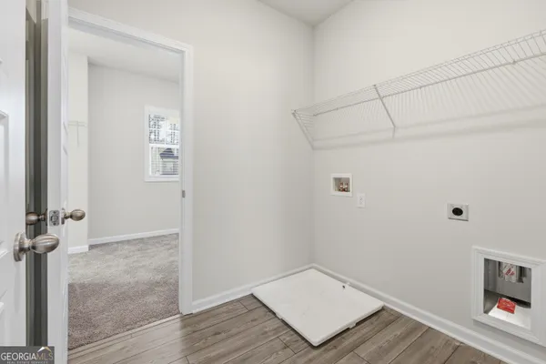 a view of a room with wooden floor