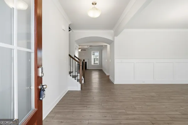a view of a hallway view with wooden floor and staircase