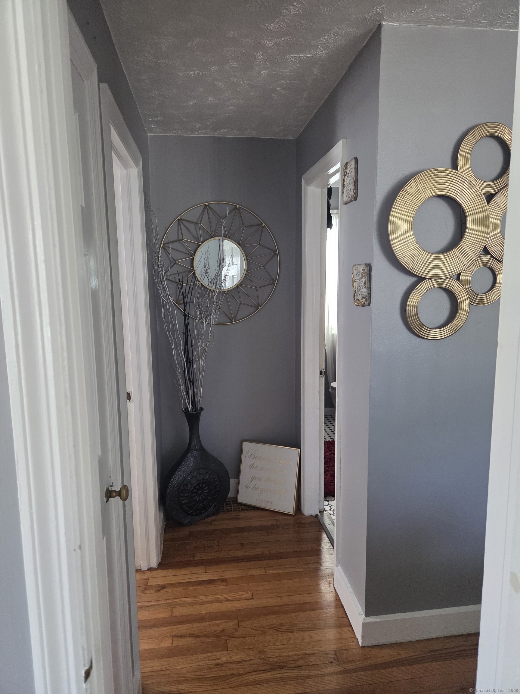 424 Circular Avenue Hamden, CT 06514 - Photo 7 of 14 a view of a hallway with wooden floor and cabinet