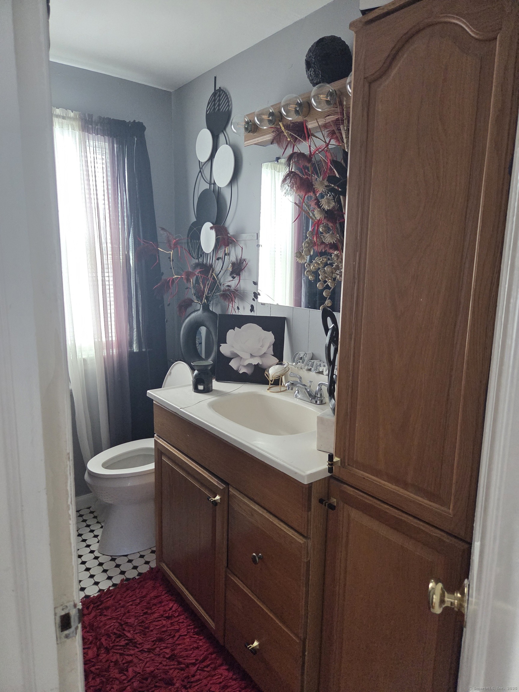 424 Circular Avenue Hamden, CT 06514 - Photo 8 of 14 a bathroom with a sink toilet and mirror