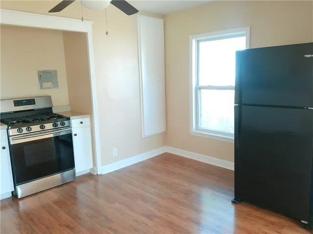 a kitchen with granite countertop a stove and a refrigerator