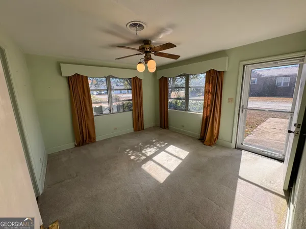 an empty room with windows and closet